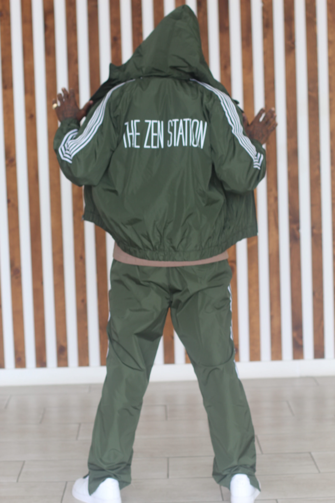 Model wearing a green The Zen Station tracksuit